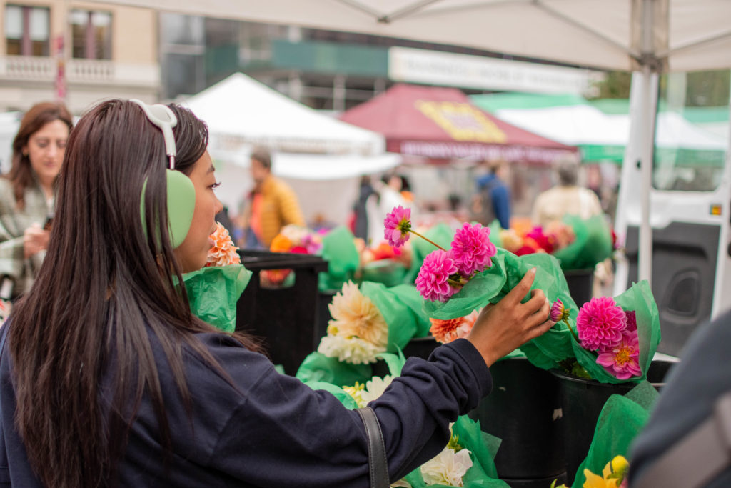 Woman picking flowers at the NYC farmer's market