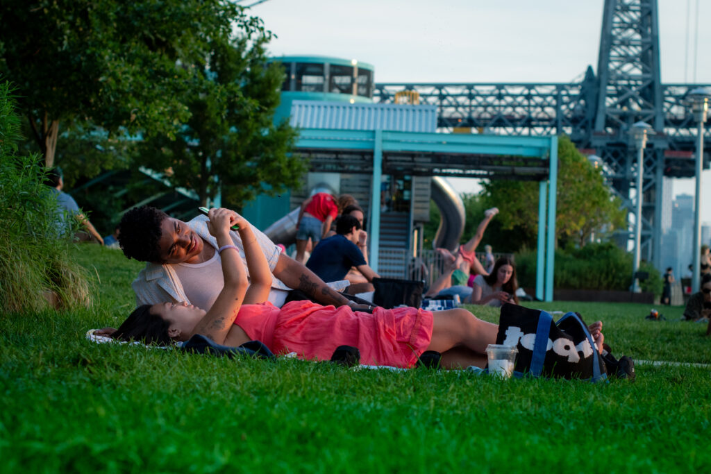 Couple laying on the grass at sunset