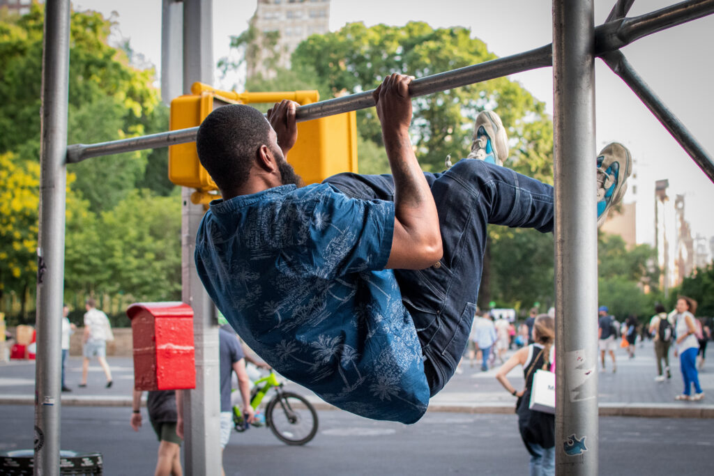 Man doing pull ups on the street